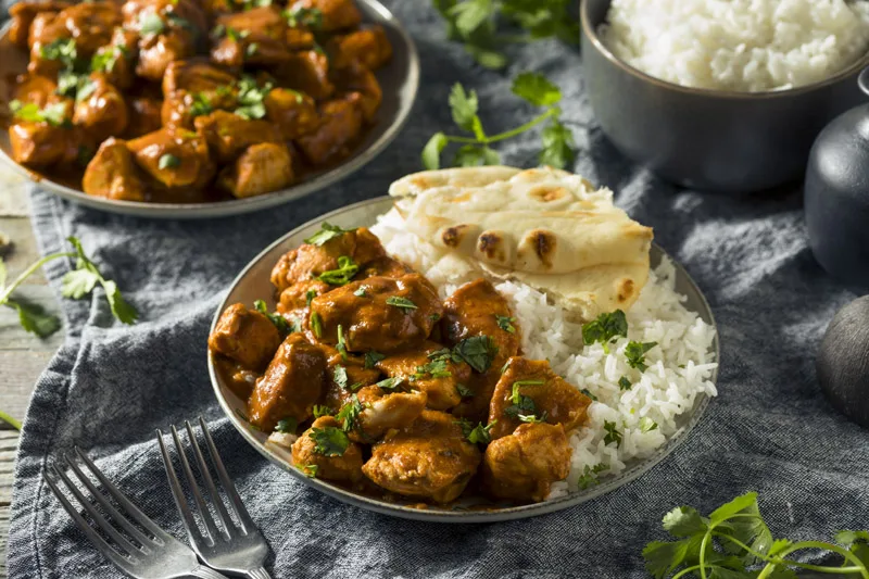 Chicken curry served with basmati rice and naan