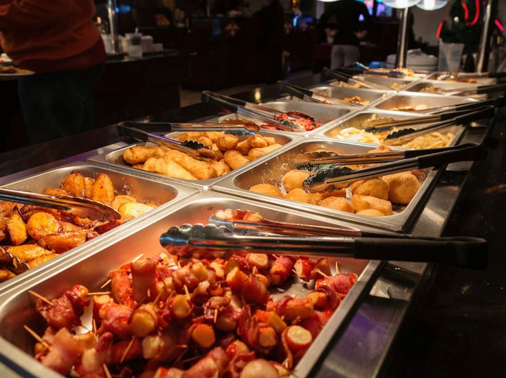 A catered buffet with hot dishes ready for guests